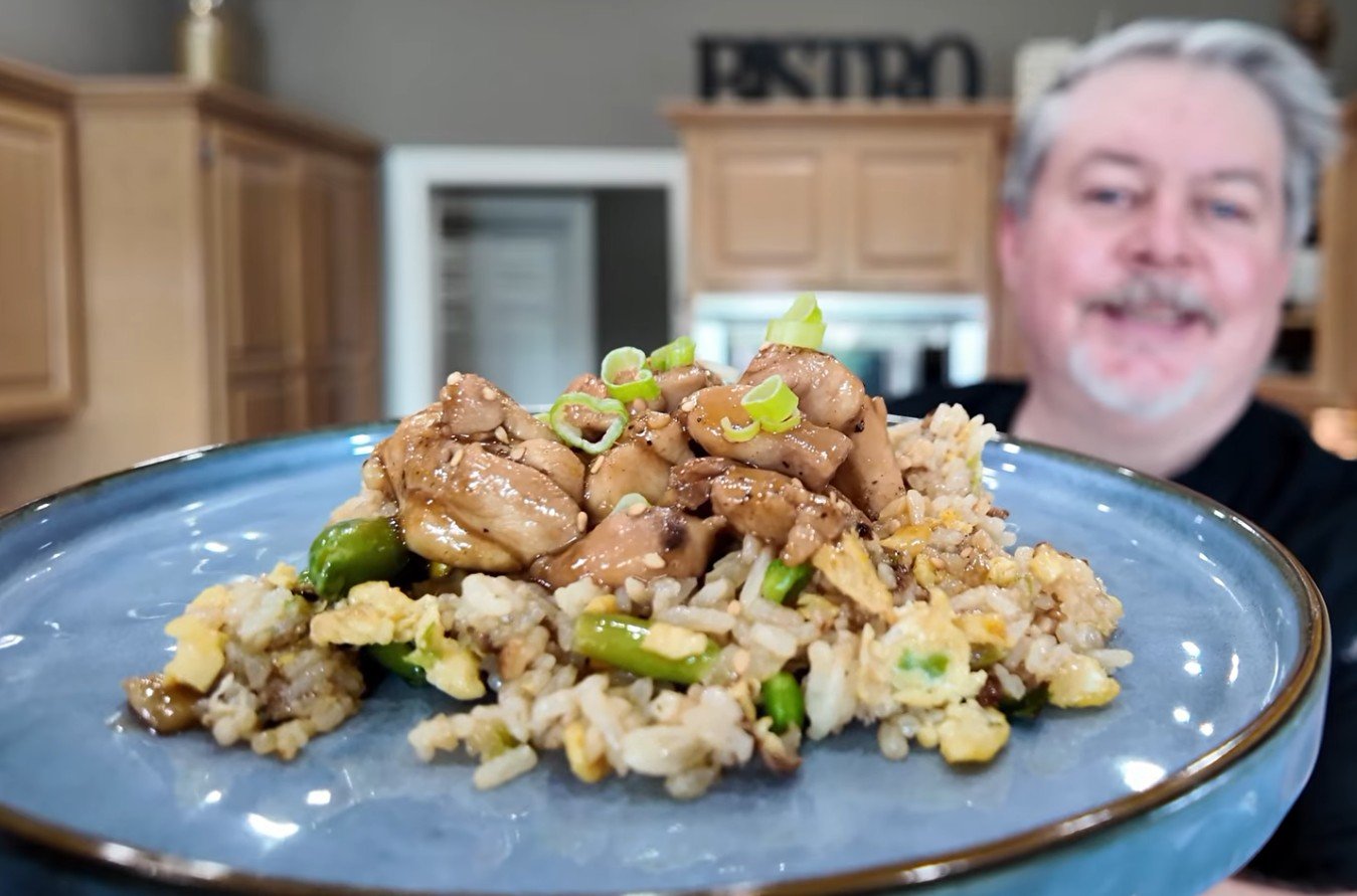 Bourbon chicken over fried rice, glazed and garnished with green onion