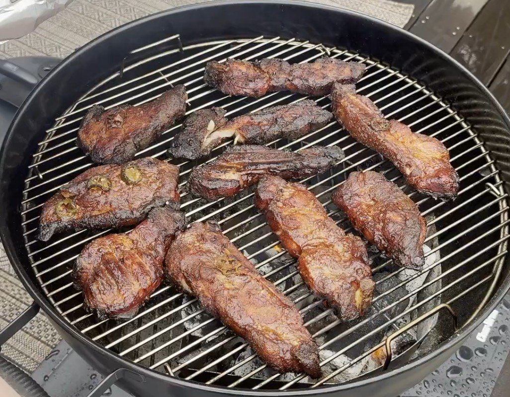 Maple bourbon country style ribs searing on a Weber kettle grill